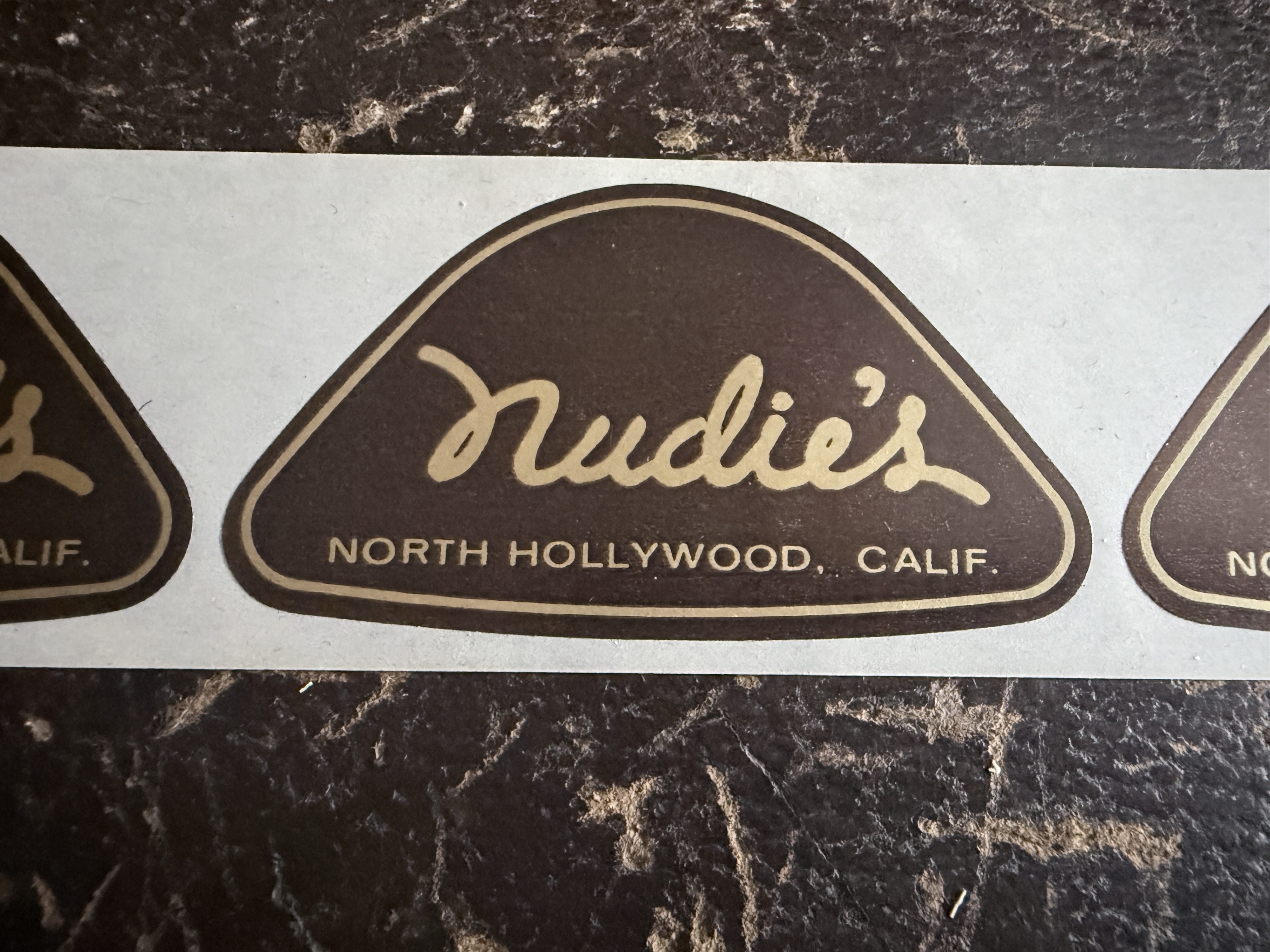 Nudie shop sticker, close view
