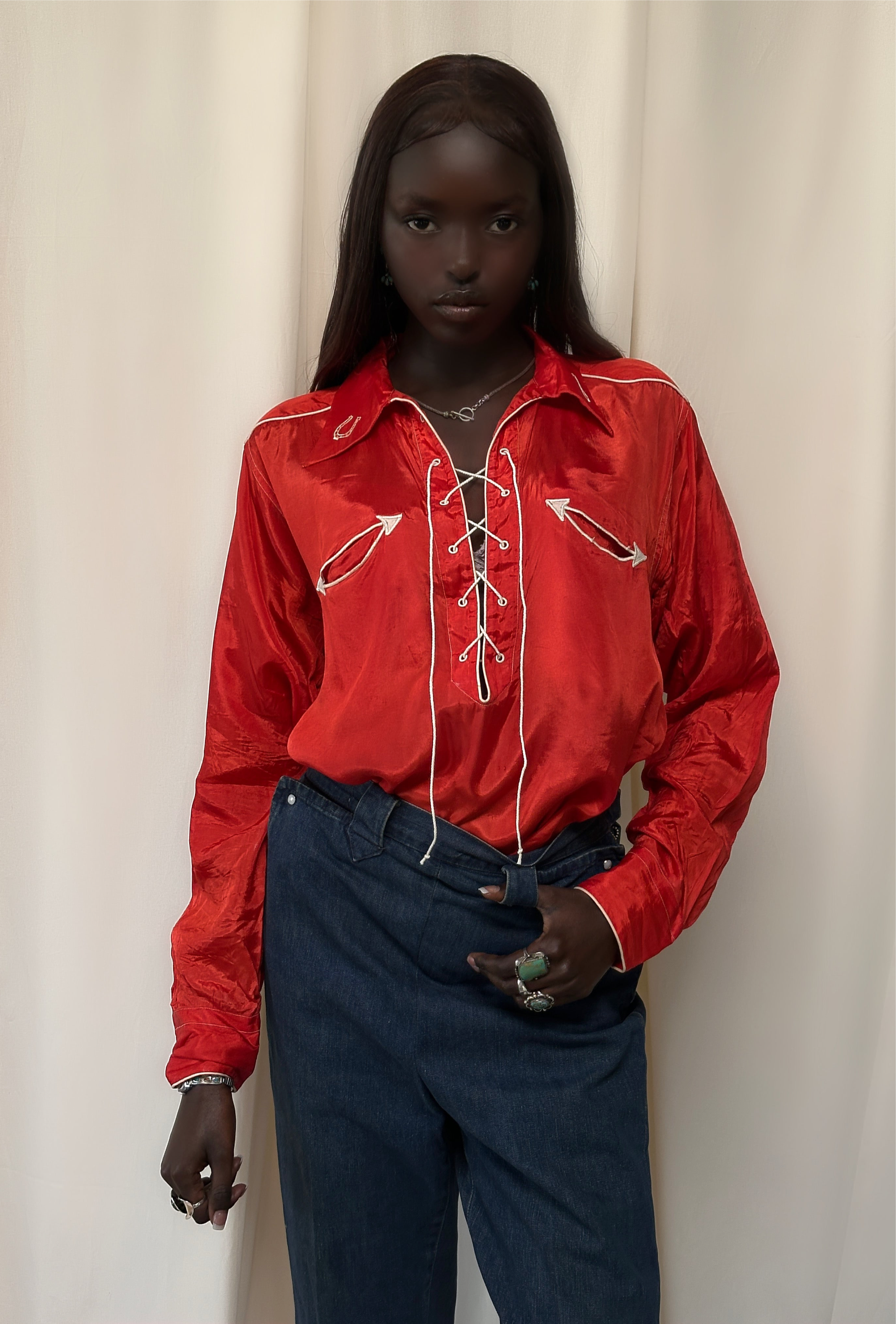 Red lace-front shirt worn