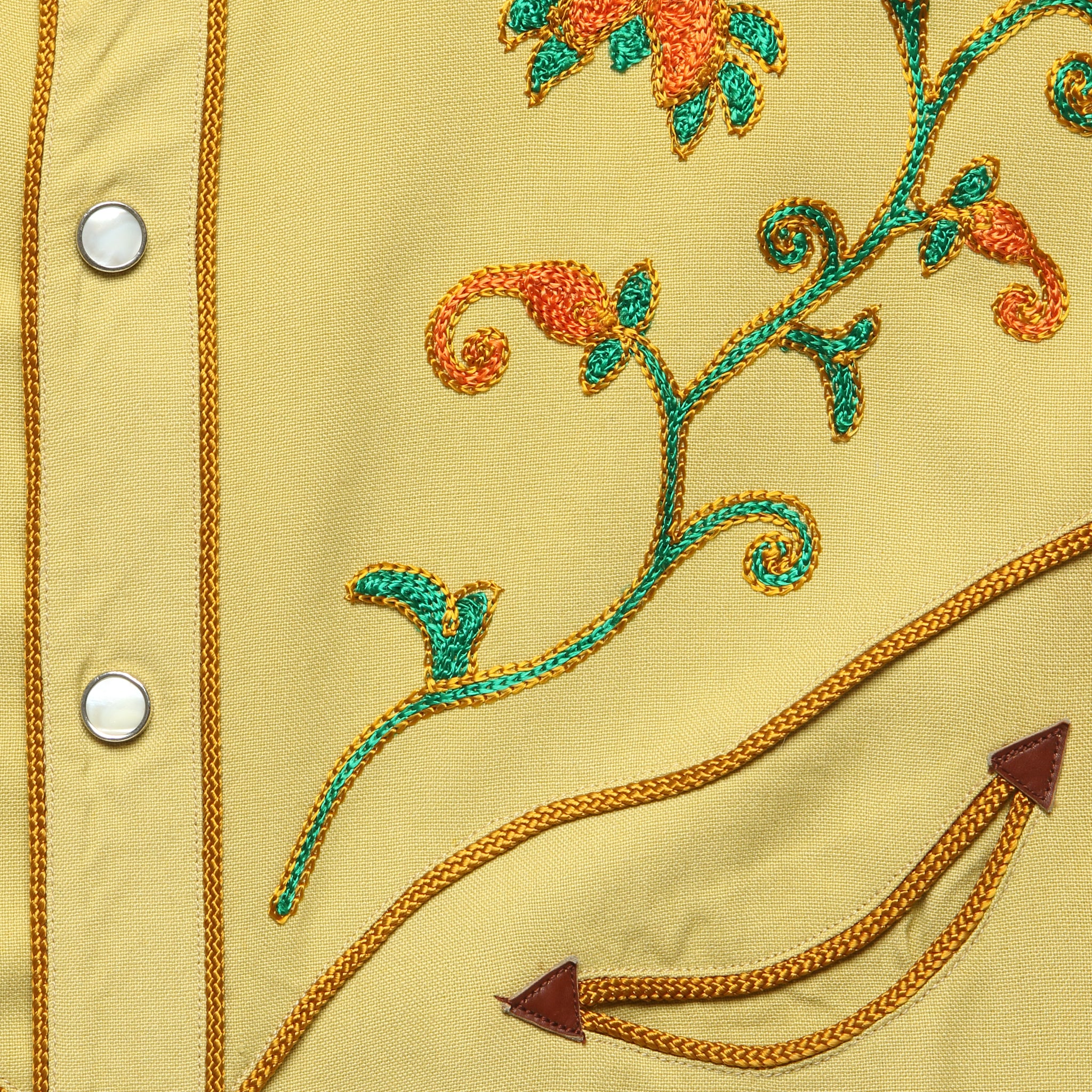 Embroidery detail on yellow Frontex shirt
