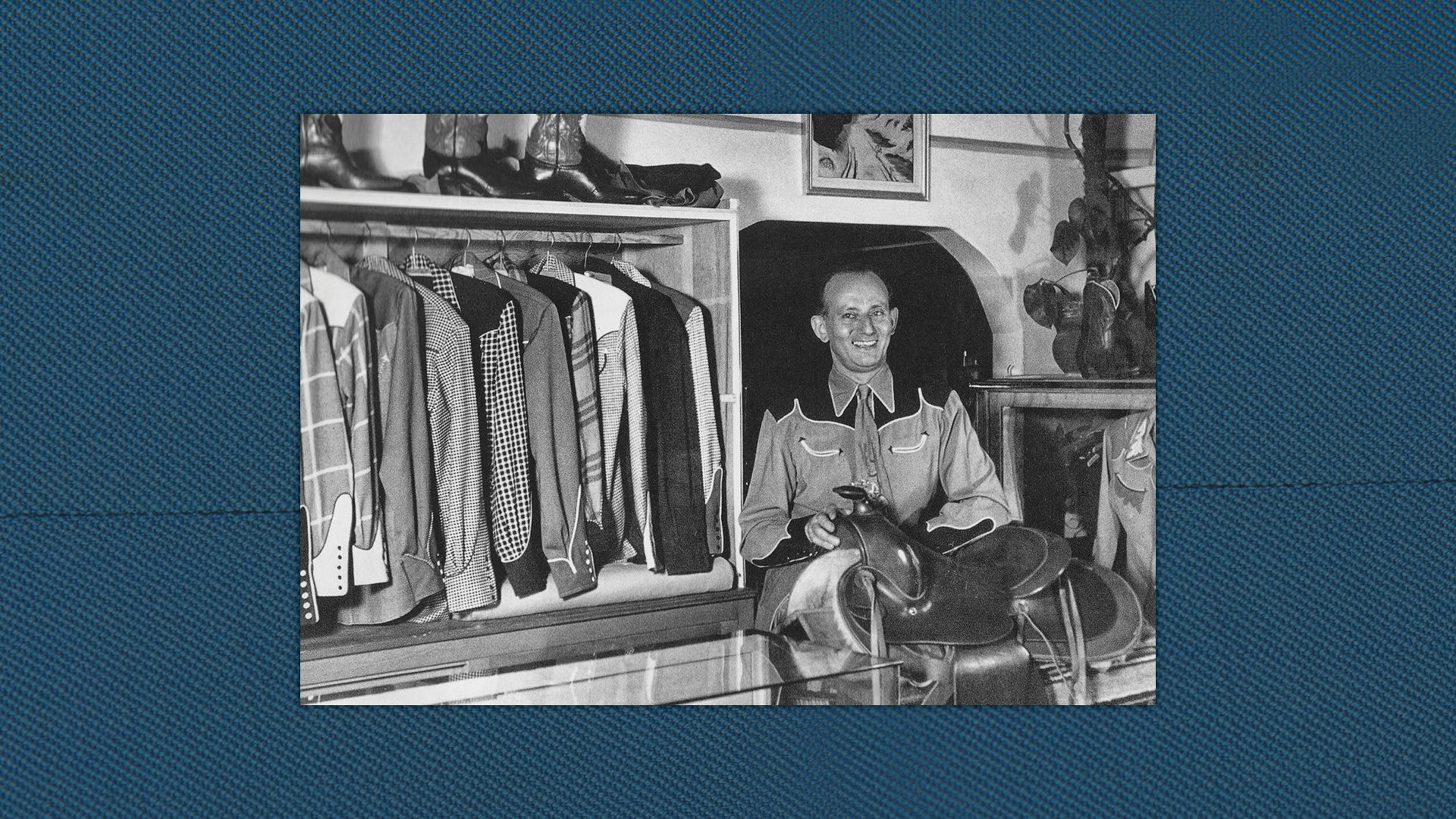 Nathan Turk at his Van Nuys shop, seated before a saddle and racks of shirts.