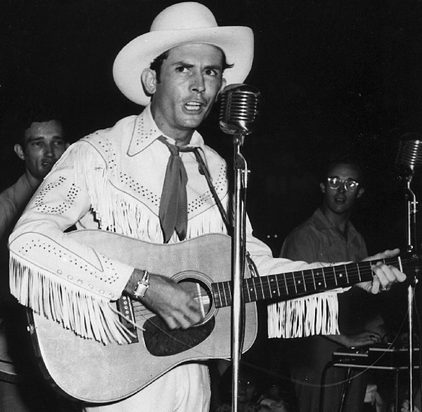 Hank Williams with an acoustic guitar, preserved in the NudieTheRodeoTailor Tumblr archive.